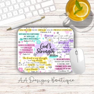 May include: A rectangular mouse pad featuring a white background with colorful hand-lettered Bible verses and inspirational text including God's Strength Within, 1 Chronicles 16:11, Matthew 19:26, Psalm 46:1, Psalm 28:7, and 2 Corinthians 4:16.