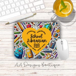 May include: A square mouse pad featuring a central yellow heart with the text School Librarian, compassionate, understanding, dedicated, reliable, genuine, positive, and an open book icon. The background is filled with colorful school supply illustrations.