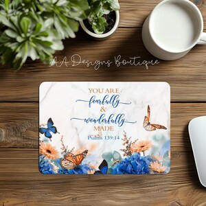 May include: A white marble background with blue and orange flowers and butterflies. The text "You are fearfully and wonderfully made" with the scripture reference "Psalms 139:14" is printed in gold.
