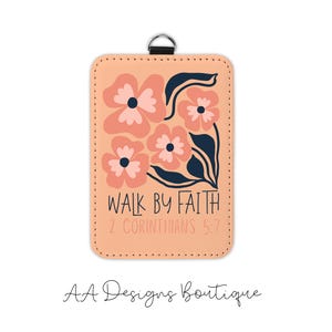 May include: A rectangular luggage tag with a peach background features a floral design in coral and navy. The text "WALK BY FAITH 2 CORINTHIANS 5:7" is printed on the tag. A black loop is attached at the top.
