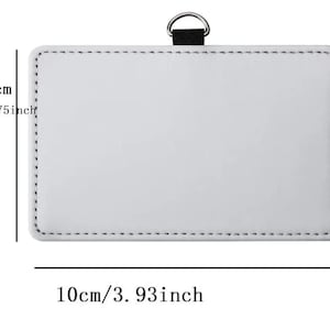 May include: A rectangular white badge holder with black stitching along the edges and a black fabric loop with a silver metal D-ring at the top. The dimensions are clearly marked as 2.75 inches in height and 3.93 inches in width.