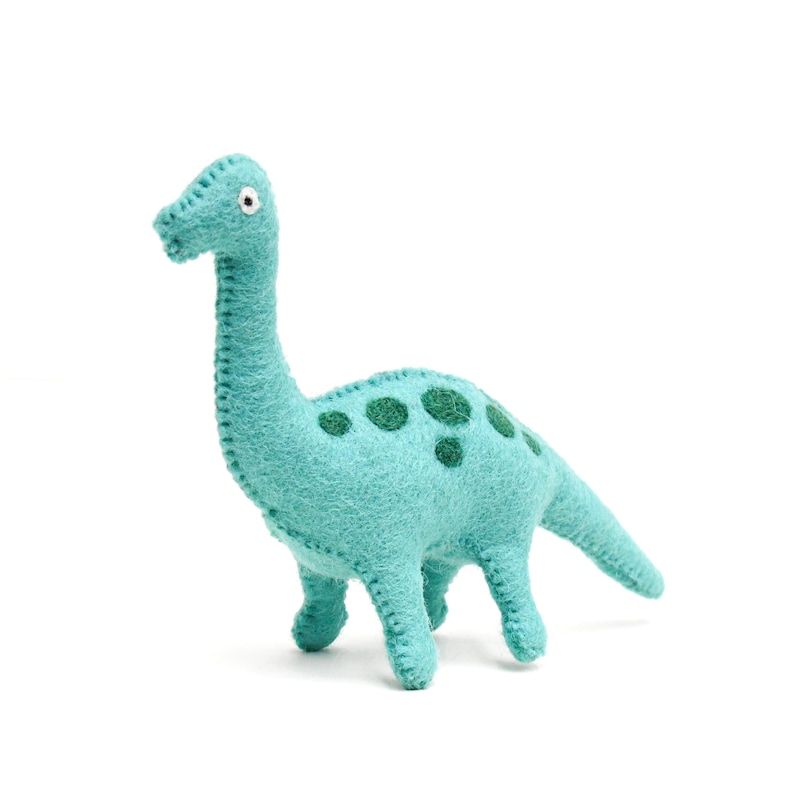 May include: A teal felt dinosaur toy with green spots. The dinosaur has a long neck and tail.