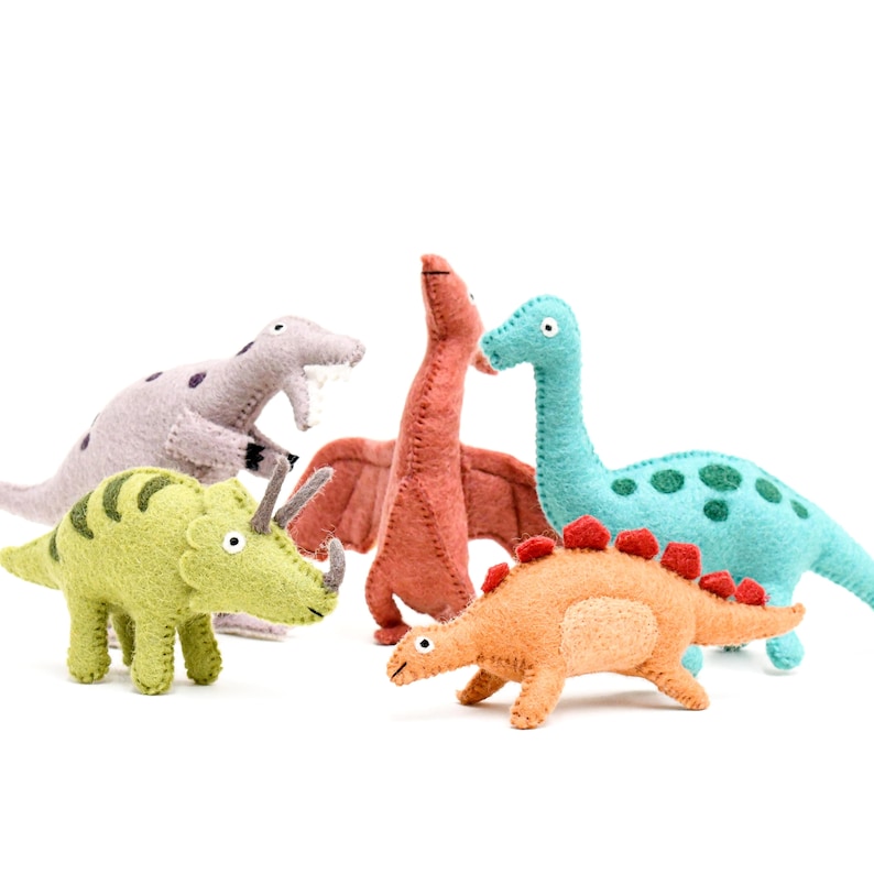 May include: Five felt dinosaur toys in various colors, including green, orange, blue, red, and purple. The dinosaurs are all different types, including a triceratops, a stegosaurus, a brachiosaurus, a pterodactyl, and a velociraptor.