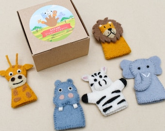 May include: A set of five felt finger puppets in a brown cardboard box. The puppets are a lion, zebra, elephant, giraffe, and hippopotamus. The box has a sticker with the words "Safari Finger Puppets".
