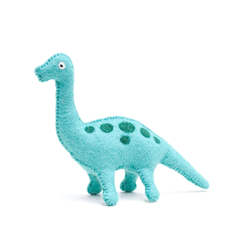 May include: A teal blue felt dinosaur toy with green felt spots. The dinosaur has a long neck and tail.