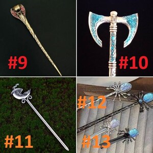 May include: Four different hair sticks with decorative tops. The first stick has a gold snake head, the second has a blue axe head, the third has a silver crescent moon with a bird, and the last three have silver spiders with blue gemstones.