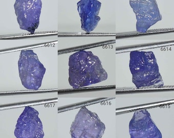 May include: Nine loose, faceted, blue gemstones, each held by tweezers. The gemstones are labeled with numbers 6609, 6610, 6611, 6612, 6613, 6614, 6615, 6616, and 6617.