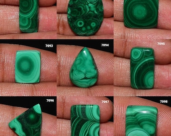 Pode incluir: Nove cabochões de malaquita verde em várias formas e tamanhos, incluindo oval, gota, quadrado e retangular. As pedras têm um padrão de espiral de verde e preto.