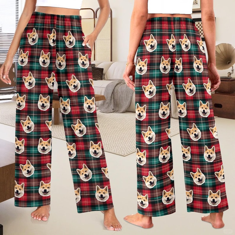 May include: Red and green plaid pyjama trousers with a repeated pattern of a dog's face. The trousers have a wide leg and an elastic waistband.