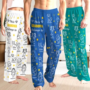 May include: Three pairs of personalized pajama pants in white, blue, and teal. Each pair features the text "This Grandma/Grandpa/Dad Belongs to" with names, star and doodle illustrations. The pajama pants are a comfortable, casual style.