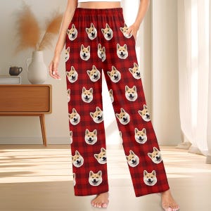 May include: Red and black checked pyjama trousers with a repeated pattern of a dog's face.