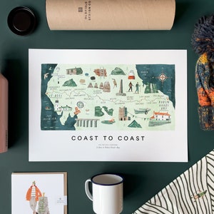 May include: A watercolour illustration of a map of the UK coastline, titled "Coast to Coast", with a compass rose and various landmarks and towns marked. The map is printed on white paper and framed with a white border.