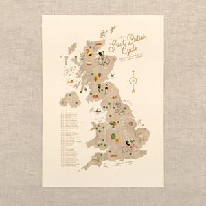 May include: A beige print depicting a map of the UK, featuring cyclists and landmarks. The title reads "The Great British Cycle". A list of locations is on the left, with a compass rose. The map is a guide to cycling routes.