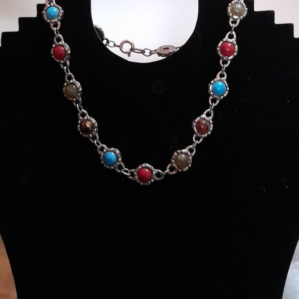 Unusual vintage necklace with varied coloured stones; turquoise, red embedded in 'silver' chain.