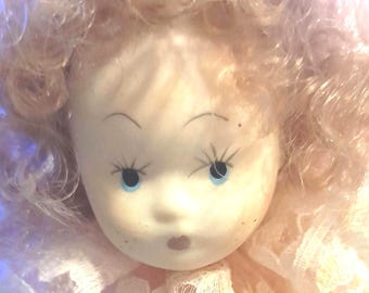 Vintage porcelain Italian doll with silk and lace dress.