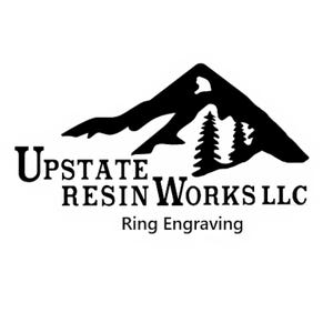 May include: Black and white logo for Upstate Resin Works LLC, a business that specializes in ring engraving. The logo features a mountain silhouette with trees in the foreground and the business name below.
