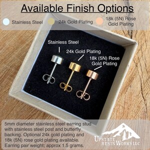 May include: A display of three stud earrings in a box, showcasing finish options: stainless steel, 24k gold plating, and 18k rose gold plating. Each earring has a 5mm diameter stud with a butterfly backing. The text reads "Available Finish Options."