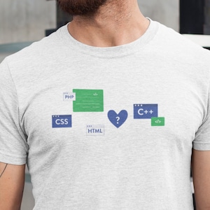 May include: A white t-shirt with a graphic design of different programming languages, including PHP, CSS, HTML, and C++. The graphic features a heart with a question mark inside.
