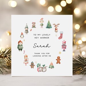 May include: A Christmas-themed greeting card with a white background. The card features a circular arrangement of festive illustrations, including elves, reindeer, and a gingerbread man. Text reads "To my lovely key worker Sarah, thank you for looking after me."