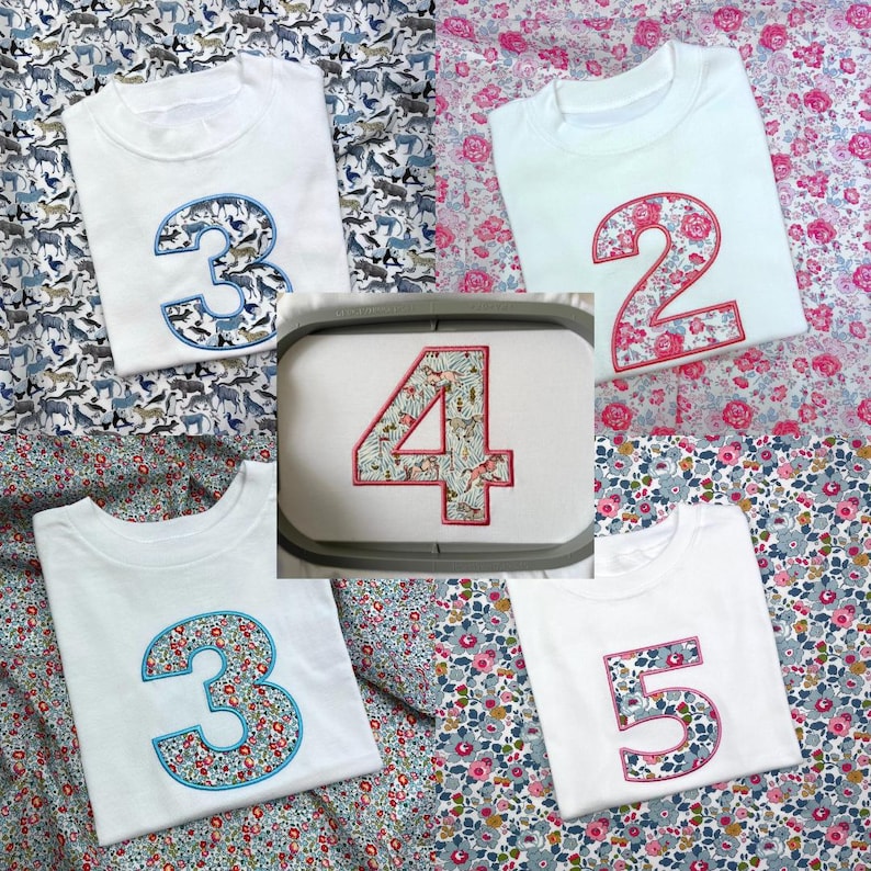 May include: A collection of white t-shirts featuring large embroidered numbers 2, 3, 4, and 5. Each number is filled with colorful floral or animal-themed fabric patterns and outlined with decorative stitching, displayed on various patterned fabrics.