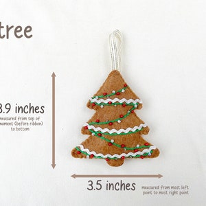 May include: A felt Christmas tree ornament in the shape of a tree with brown felt, white felt trim, red beads, and green felt garland. The ornament is 3.9 inches tall and 3.5 inches wide.