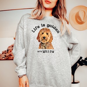May include: A gray sweatshirt with the text "Life is golden with Willow" and a cartoon image of a golden doodle dog.