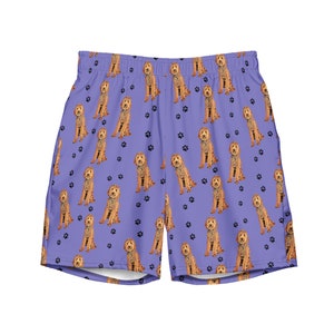 May include: Purple athletic shorts with a repeating pattern of brown dogs and paw prints.