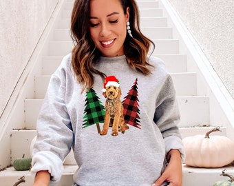 May include: A gray sweatshirt with a red and green plaid Christmas tree design and a doodle dog wearing a Santa hat.