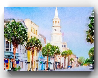 May include: Watercolor painting of a street scene with buildings and palm trees. A tall white church steeple dominates the background. The buildings are painted in shades of blue, yellow, and white, with a clear blue sky.