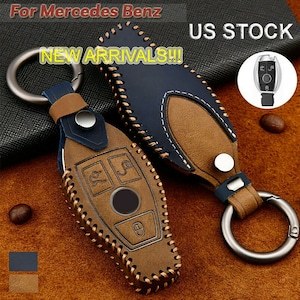 May include: Leather key fob covers for Mercedes Benz vehicles. The key fobs are brown and navy blue with decorative stitching and a metal keyring. The image includes the text "NEW ARRIVALS!!!" and "US STOCK".