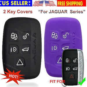 May include: Black and purple key covers for a Jaguar series car key. The covers have white icons for lock, unlock, lights, and trunk release. The image also shows a car key with silver trim. The text says "2 Key Covers For JAGUAR Series".