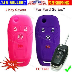 May include: Two key covers, one pink and one purple, designed for a Ford series vehicle. The pink cover is on the left, and the purple cover is on the right. The image also shows a black car key.