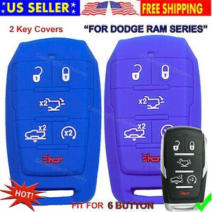 May include: Two key covers, one blue and one purple, for a Dodge Ram series key fob. The blue cover has white icons and the text "x2". The purple cover has white icons and the text "x2". The image also shows a black key fob.