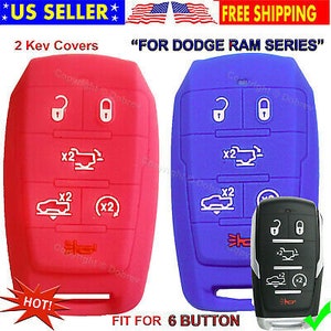 May include: Red and blue key fob covers for a Dodge Ram series vehicle. The covers have white icons and text, including "x2" and key symbols. The image also shows a black key fob and text that says "FIT FOR 6 BUTTON".
