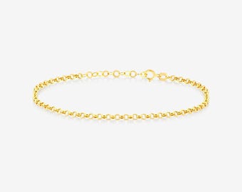 May include: A delicate gold chain bracelet featuring a series of uniform, rounded circular links connected in a continuous pattern. The bracelet includes a small, secure spring ring clasp mechanism at one end for fastening the jewelry piece.