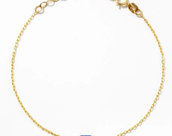 May include: A delicate gold chain bracelet featuring a single rectangular baguette-cut blue gemstone set in a gold bezel. The bracelet includes a thin link chain, a small circular spring ring clasp, and an adjustable extender chain with small links.