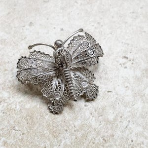 Silver filigree butterfly brooch