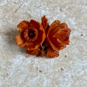 Vintage orange/ brown carved Bakelite brooch with tea rose and garden rose design.