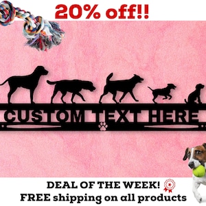 May include: Black metal dog silhouette wall decor with the text "CUSTOM TEXT HERE" and a paw print. Five dog silhouettes are arranged in a row above the text. The background is pink.