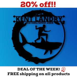May include: Black metal silhouette of a person surfing on a shark with the text "KENT LANDRY: ESTABLISHED 2004" in a circle around the image. The text "20% off!!" is at the top of the image and the text "DEAL OF THE WEEK! FREE shipping on all products" is at the bottom of the image.