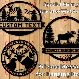 May include: Three black metal round signs with a mountain, moose, and deer design. Each sign has a banner with the text "CUSTOM TEXT", "REQUEST HANGING HOLES", and "PERSONAL MESSAGES". The signs have a rustic wood background.