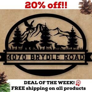 May include: Black metal sign with a mountain scene, a bear, a fox, and two trees. The sign also includes the text "4070 BRYDLE ROAD".