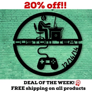 May include: Black metal wall art featuring a gamer at a desk with a headset, a controller, and the text "CUSTOM TEXT" and "12/14/14" within a circular frame. The background is a green brick wall.