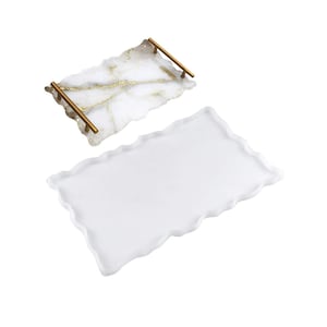 May include: Two white resin serving trays with gold accents. The top tray has a gold metallic finish and gold handles. The bottom tray is plain white.