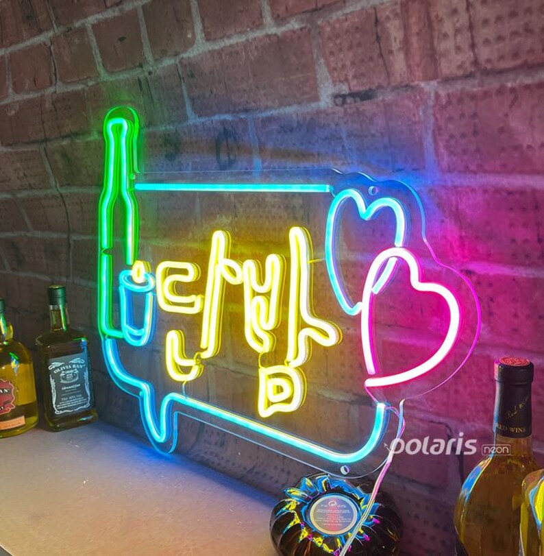 May include: Neon sign with a yellow speech bubble containing Korean text and a pink heart. The speech bubble is outlined in blue and green. The sign is mounted on a brick wall.