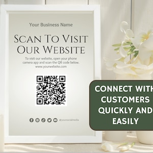 QR code sign is in a white picture frame and sits on a white table with white flowers and white wood background. Reads Connect with customers quickly and easily. The sign has a large QR code in the middle for you to replace with your own qr code.