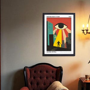 May include: Framed art print featuring a stylized illustration from George Orwell's "Nineteen Eighty-Four." The artwork depicts a large eye, a figure, and city buildings in a retro style, with a red, yellow, and blue color scheme.