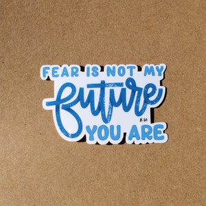 May include: Blue and white sticker with the text "Fear is not my future you are" in a handwritten style.