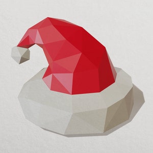 May include: A red and white paper Santa hat with a white pom-pom on top. The hat is made of folded paper and has a geometric design.