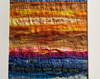 Framed Emboidered Lyrics - Sunshine On My Shoulders - John Denver. Music and Textile Art.